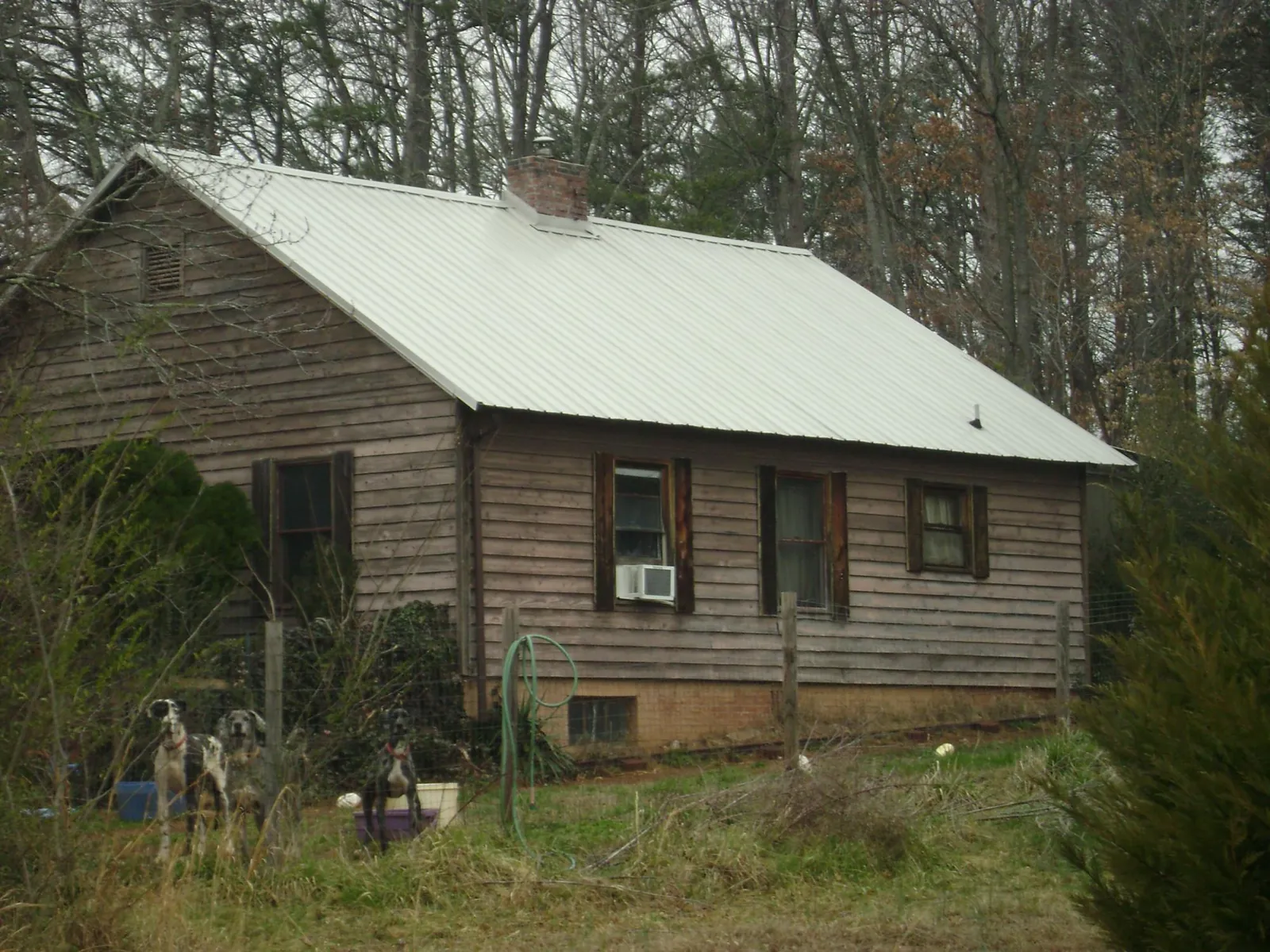 White metal roof on an old wood sided farmhouse, from a Asphalt Shingle Roof Repair job in Millersport